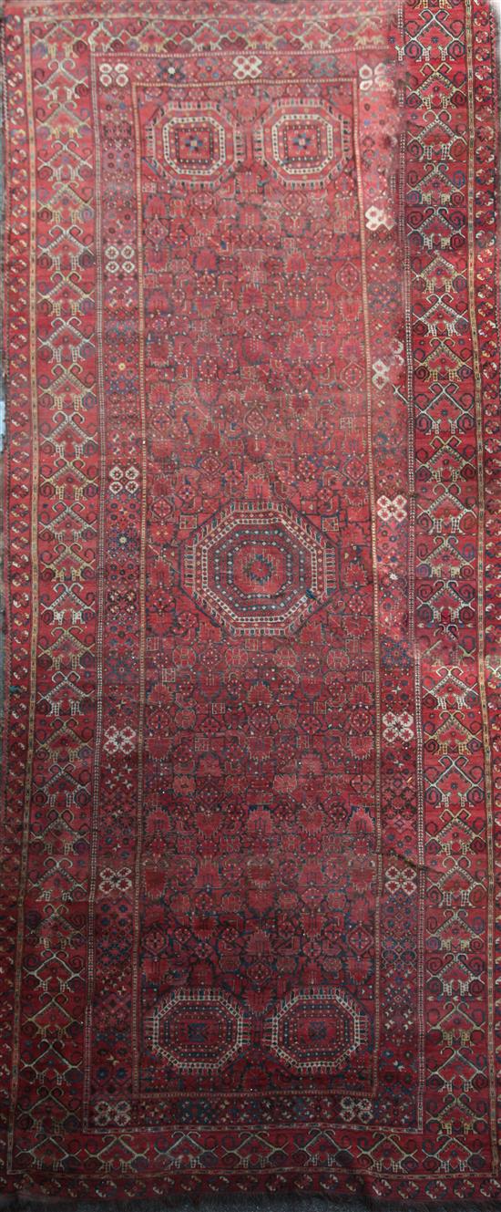 A large Persian carpet, 20ft 8in by 8ft 6in.